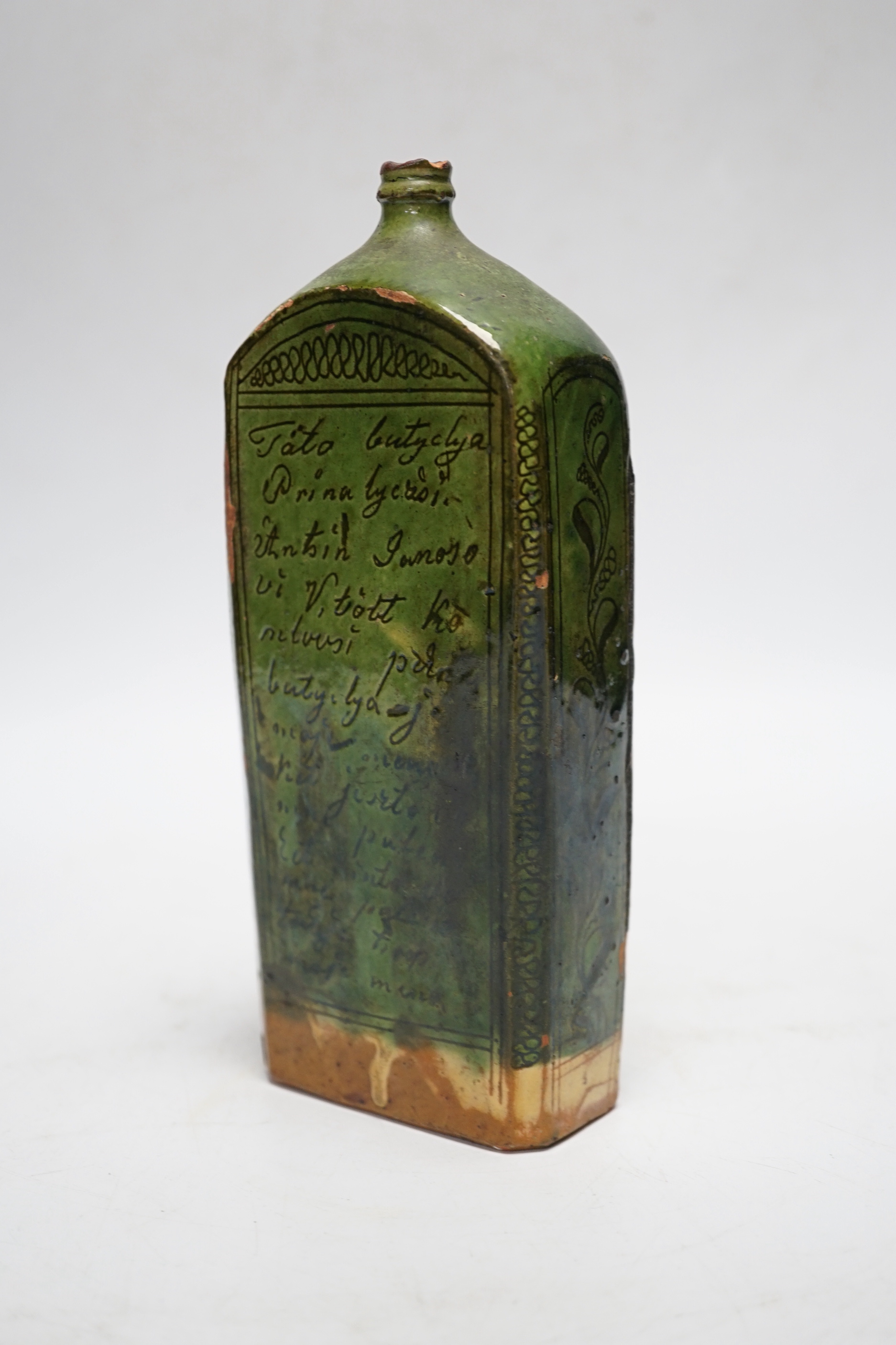 A 19th century green glazed terracotta sgraffito flask, 19cm